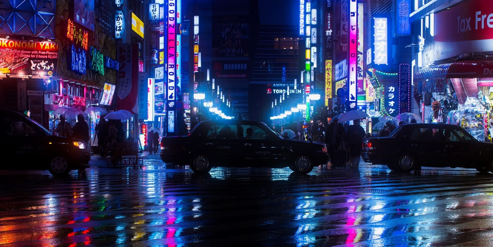 Neon-lit city street at night